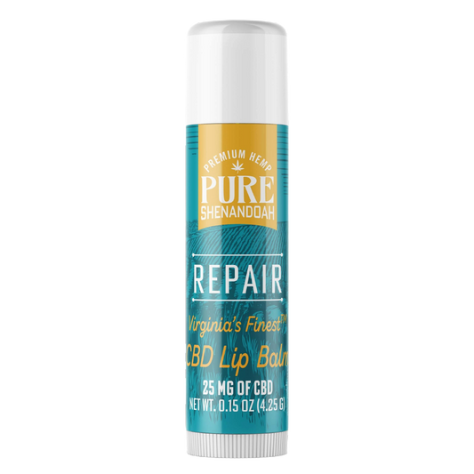 Pure Shenandoah Repair CBD Lip Balm tube, teal and gold label with brand logo, 25 mg CBD, and net weight of 0.15 oz (4.25 g).